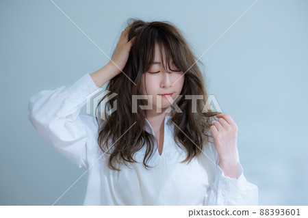 Women in white blouse hair care worries Women in white blouse hair care worries 88393601