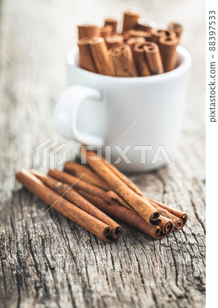 Dry cinnamon sticks on wooden table. Cinnamon spice. Dry cinnamon sticks on wooden table. Cinnamon spice. 88397533