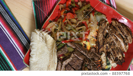 Beef and Chicken Fajita Meal on Table With Rice and Tortillas 88397768