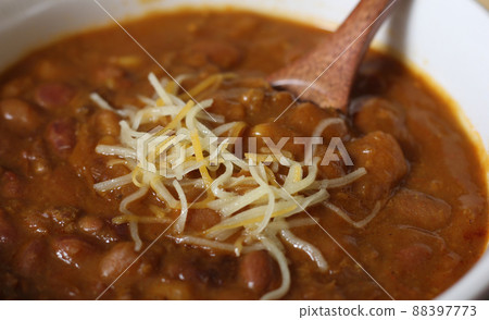 Bowl of Chili With Pinto Beans on Table With Peppers and Dry Beans in Background 88397773