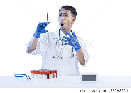 Asian nerd scientist standing and holding a syringe with medical tube rack on the desk Asian nerd scientist standing and holding a syringe with medical tube rack on the desk 88398224