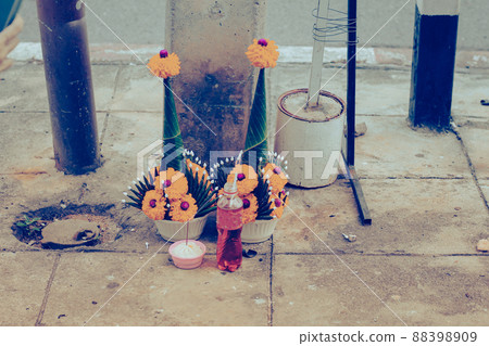 Marigold flowers and sweet drinks as religious offerings to the spirits in the streets of Bangkok City, Thailand Marigold flowers and sweet drinks as religious offerings to the spirits in the streets of Bangkok City, Thailand 88398909