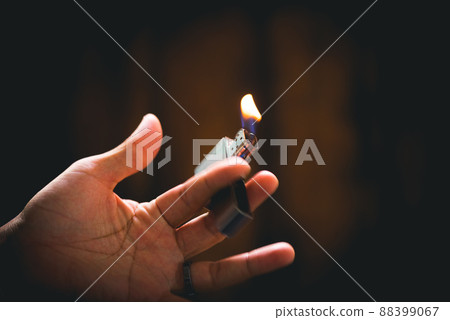 metal lighter in man's hand 88399067