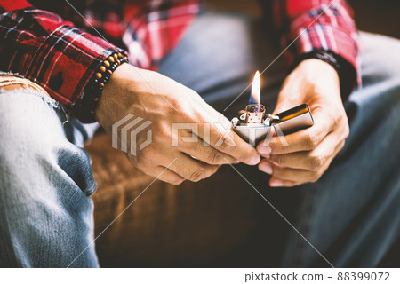 metal lighter in man's hand 88399072