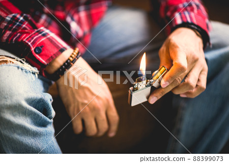 metal lighter in man's hand metal lighter in man's hand 88399073