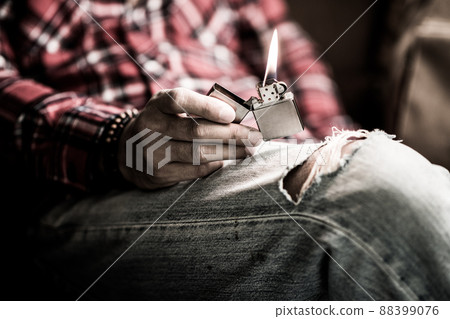 metal lighter in man's hand 88399076
