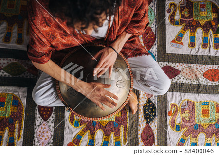 Close-up of a man's hand playing a modern musical instrument, the orion reed drum 88400046