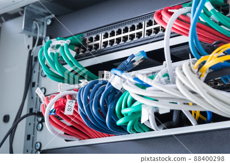 fiber optic cables connected to optic ports, network cables connected to ethernet ports 88400298