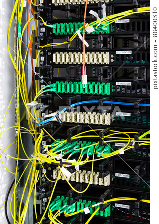 Fiber Optic cables connected to an optic ports - data switch in internet data center Fiber Optic cables connected to an optic ports - data switch in internet data center 88400310
