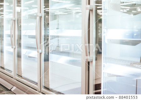 Empty refrigerator or freezer for food and grocery items in store. Selective focus. 88401553