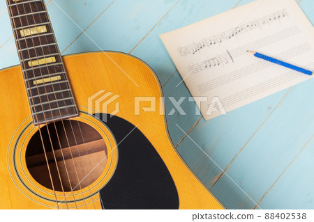 acoustic guitar pencil and music sheet acoustic guitar pencil and music sheet 88402538