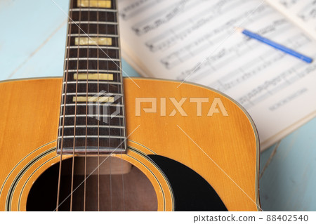 acoustic guitar pencil and music sheets acoustic guitar pencil and music sheets 88402540