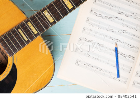view from above of acoustic guitar pencil and music sheets view from above of acoustic guitar pencil and music sheets 88402541