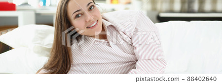 Brunette girl laying in bed Brunette girl laying in bed 88402640