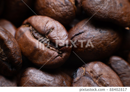 Close up extreme macro group of roasted brown or black coffee beans background in shallow depth of field. Enchanting coffee aroma Close up extreme macro group of roasted brown or black coffee beans background in shallow depth of field. Enchanting coffee aroma 88402817