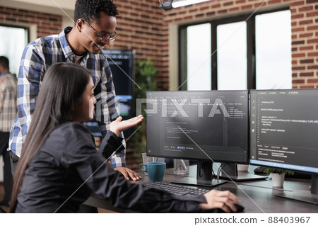 Programmers questioning source of cyber attacks and system security coverage. Software technician triangulates hacker location by updating safety script codes and data processor sequencer. 88403967