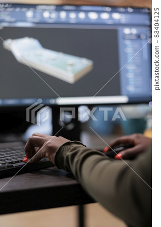 Close up of digital artist working on 3D model to improve geometry and optimise project. Graphics industry person with high modelling skills working with advanced software technology. Close up of digital artist working on 3D model to improve geometry and optimise project. Graphics industry person with high modelling skills working with advanced software technology. 88404125