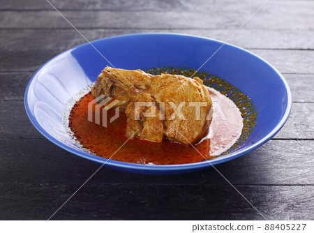 Close up chicken Mussaman Curry - spicy Muslim curry in blue dish on black table Close up chicken Mussaman Curry - spicy Muslim curry in blue dish on black table 88405227