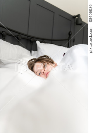 Sleepy teenager girl in bed Sleepy teenager girl in bed 88406086