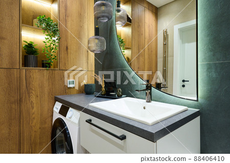Part of bathroom with treetop green marble wall and wooden closet Part of bathroom with treetop green marble wall and wooden closet 88406410