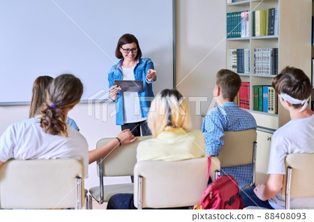 Lesson in classroom with digital screen for group of teenagers Lesson in classroom with digital screen for group of teenagers 88408093
