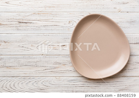 Top view of empty pink plate on wooden background. Empty space for your design 88408159