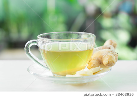 Closeup Fresh ginger with sliced and hot ginger glass on white white table, herb and medical for health concept 88408936