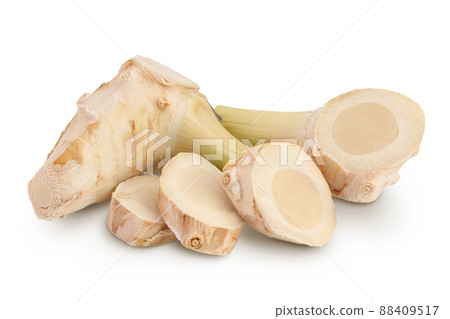 Fresh galangal root with slices isolated on white background with clipping path and full depth of field. Fresh galangal root with slices isolated on white background with clipping path and full depth of field. 88409517