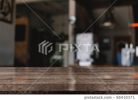 Empty wooden table top with lights bokeh on blur restaurant background. Empty wooden table top with lights bokeh on blur restaurant background. 88410371