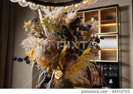 Floral door wreath made of colorful dry summer flowers and plants, close up. Fall wildflowers decoration. Natural background. 88410703