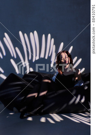 woman in black bodysuit in the backlight of a photo studio. woman in black bodysuit in the backlight of a photo studio. 88410791