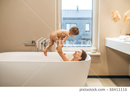 Joyous female parent playing with her child 88411118