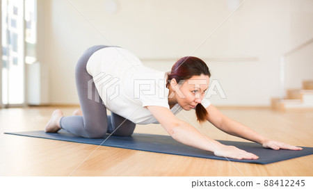Pregnant woman is engaged in yoga. Baby asana or Balasana Pregnant woman is engaged in yoga. Baby asana or Balasana 88412245