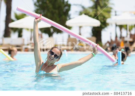 Beautiful woman goes in for sports in pool Beautiful woman goes in for sports in pool 88413716