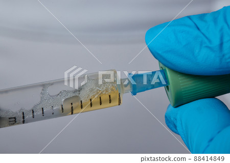 Beautician doctor's hands put test tube with blood in centrifuge container. Rejuvenation plasmolifting procedure. 88414849