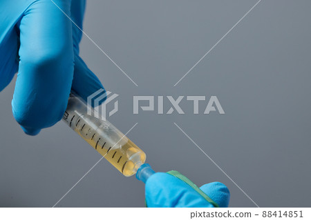 Beautician doctor's hands put test tube with blood in centrifuge container. Rejuvenation plasmolifting procedure. Beautician doctor's hands put test tube with blood in centrifuge container. Rejuvenation plasmolifting procedure. 88414851