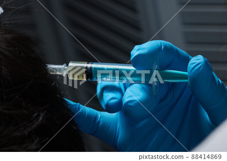 Injection plasma into head hair man cosmetologist doctor. Injection plasma into head hair man cosmetologist doctor. 88414869