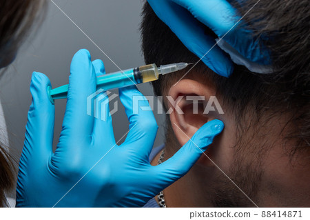 Injection plasma into head hair man cosmetologist doctor. Injection plasma into head hair man cosmetologist doctor. 88414871