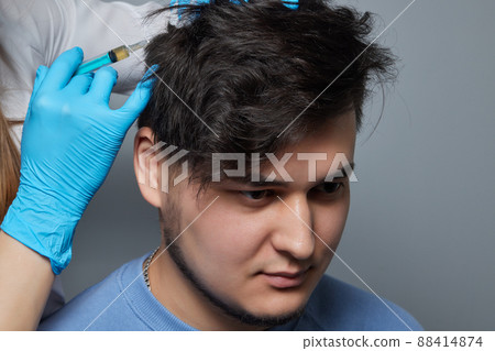 Injection plasma into head hair man cosmetologist doctor. 88414874