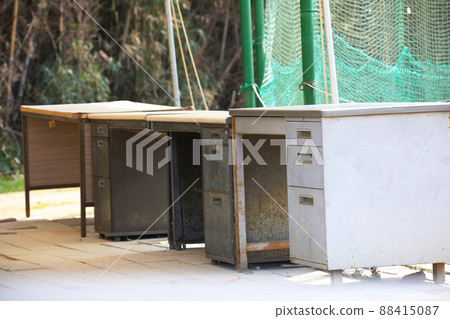 An old office desk left outdoors An old office desk left outdoors 88415087