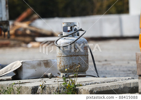 Old propane gas randomly placed on an outdoor work site Old propane gas randomly placed on an outdoor work site 88415088