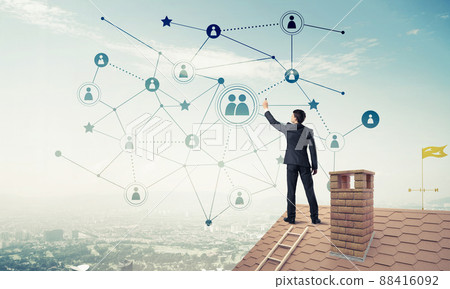 Businessman on house roof presenting networking and connection c 88416092
