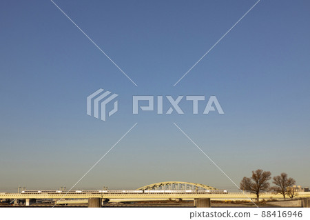 Romancecar EXEα crossing the Tama River in the morning 88416946