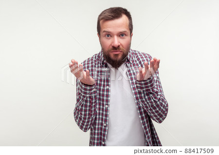 How could you. Portrait of upset bearded man in casual plaid shirt raising hands looking confused disgruntled at camera, waiting for explanation. indoor studio shot isolated on white background How could you. Portrait of upset bearded man in casual plaid shirt raising hands looking confused disgruntled at camera, waiting for explanation. indoor studio shot isolated on white background 88417509