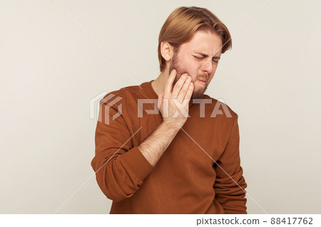 Portrait of emotional bearded man on gray background. 88417762