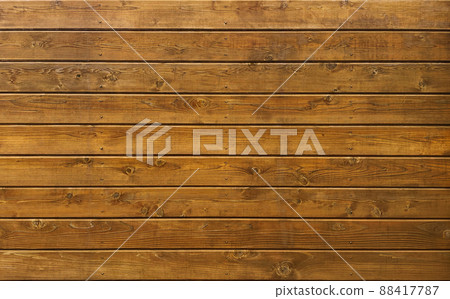 Background image of a brown board with wood grain and knots covered with round-headed brass nails 88417787
