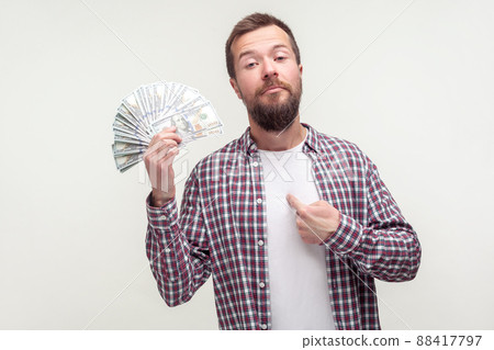 I made money myself. Portrait of arrogant bearded man in casual plaid shirt pointing at himself and holding dollars, proud of big earnings, startup. indoor studio shot isolated on white background I made money myself. Portrait of arrogant bearded man in casual plaid shirt pointing at himself and holding dollars, proud of big earnings, startup. indoor studio shot isolated on white background 88417797
