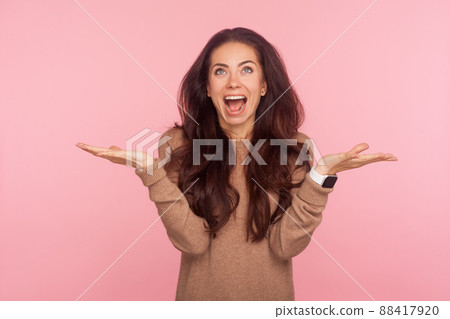 I have no idea. Portrait of excited happy young woman with brunette wavy hair shrugging shoulders in bewilderment, gesturing I don't know, who cares, so what. studio shot isolated on pink background I have no idea. Portrait of excited happy young woman with brunette wavy hair shrugging shoulders in bewilderment, gesturing I don't know, who cares, so what. studio shot isolated on pink background 88417920