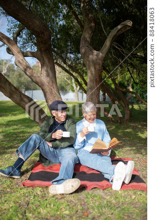 Portrait of aged couple enjoying morning in park Portrait of aged couple enjoying morning in park 88418063