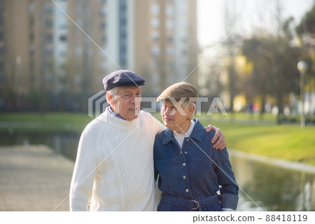 Portrait of aged couple spending free time in park 88418119